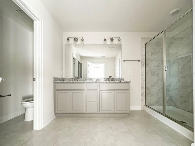 bathroom featuring vanity, toilet, a shower with door, and tile patterned floors