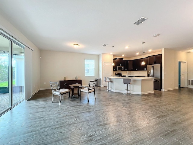 dining area with light wood-type flooring and sink