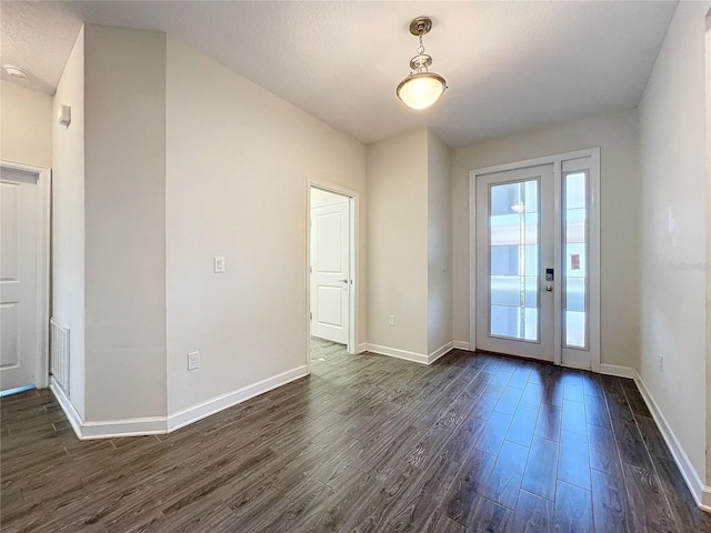 foyer entrance with dark hardwood / wood-style floors