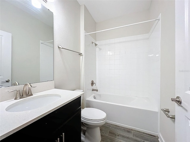 full bathroom featuring vanity, toilet, hardwood / wood-style floors, and tiled shower / bath