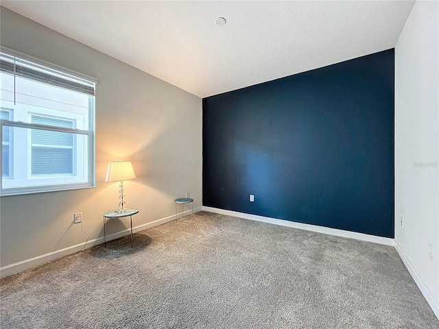 unfurnished room with carpet flooring