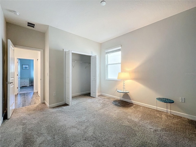 unfurnished bedroom with a closet and carpet floors