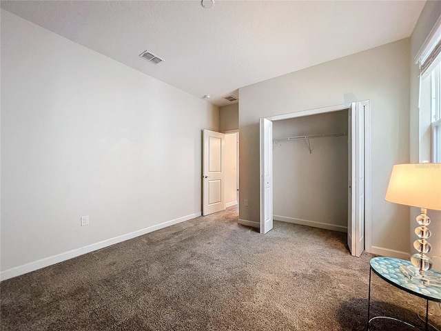 unfurnished bedroom featuring a closet and carpet