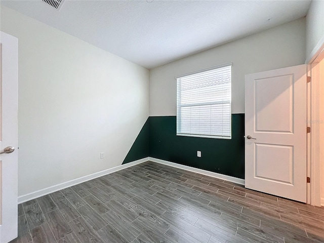 spare room featuring dark hardwood / wood-style floors