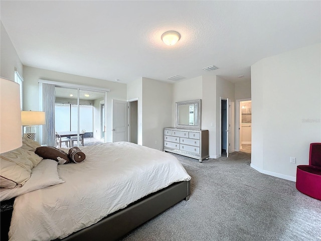 carpeted bedroom featuring ensuite bath