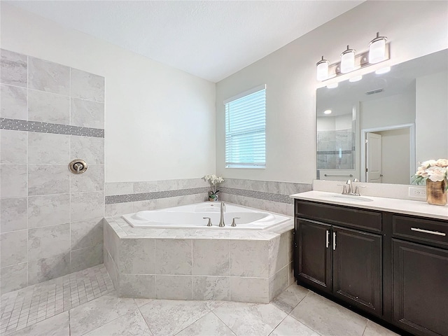 bathroom featuring vanity, tile patterned floors, and shower with separate bathtub