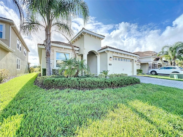 mediterranean / spanish-style house featuring a garage and a front yard