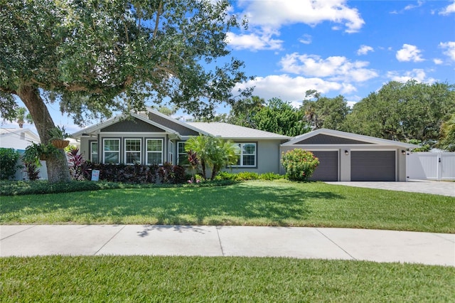 single story home featuring a front yard and a garage