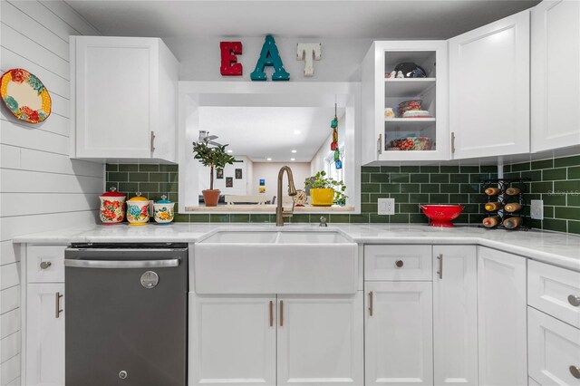 kitchen with dishwasher, backsplash, white cabinetry, and sink