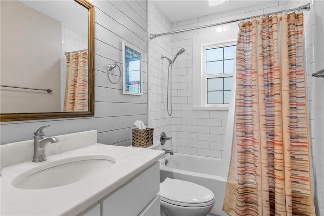 full bathroom featuring wooden walls, vanity, shower / bath combo, and toilet