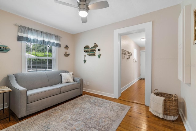 living room with hardwood / wood-style floors and ceiling fan