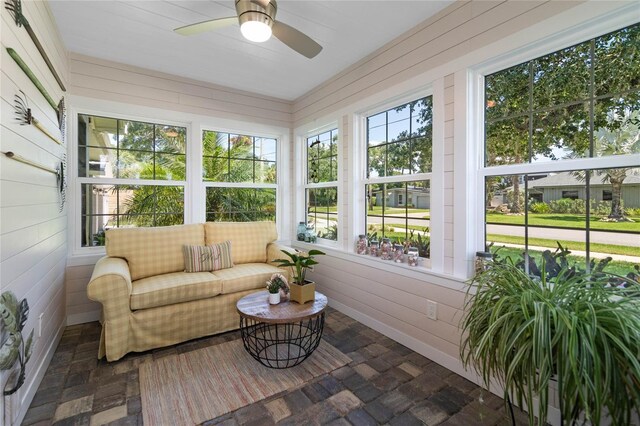 sunroom / solarium featuring ceiling fan and plenty of natural light