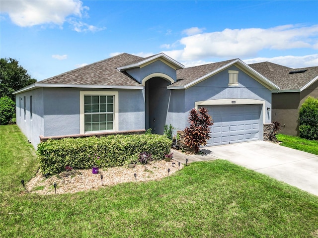 single story home with a garage and a front lawn