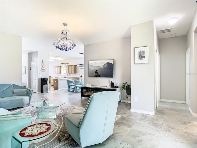 living room featuring sink and a notable chandelier