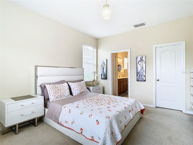 carpeted bedroom with ensuite bath