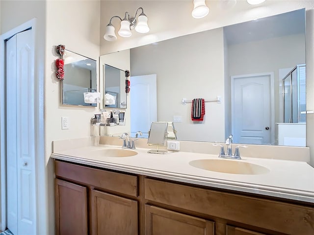 bathroom featuring an enclosed shower and vanity