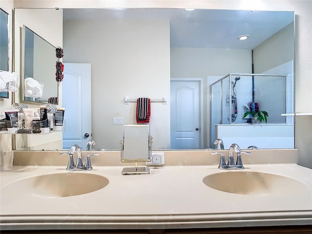 bathroom with vanity and a shower with shower door