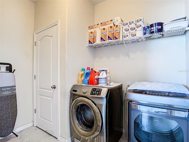 laundry area featuring washing machine and clothes dryer