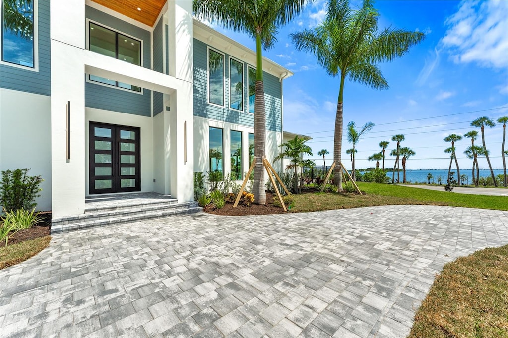 doorway to property with french doors and a water view