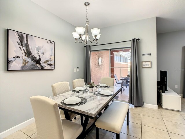 tiled dining area with an inviting chandelier