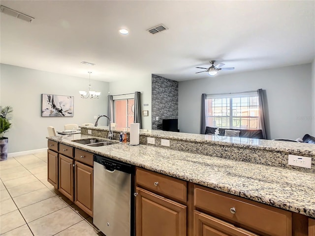 kitchen featuring dishwasher, ceiling fan with notable chandelier, light stone countertops, sink, and a stone fireplace