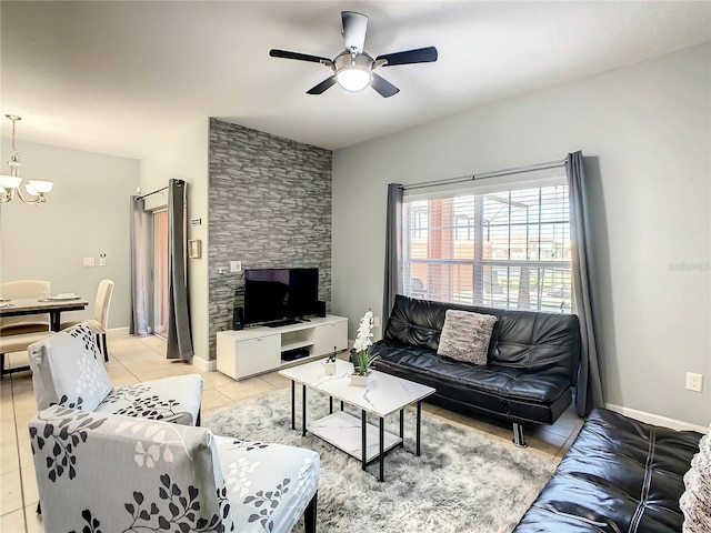 living room featuring ceiling fan with notable chandelier and light tile patterned flooring