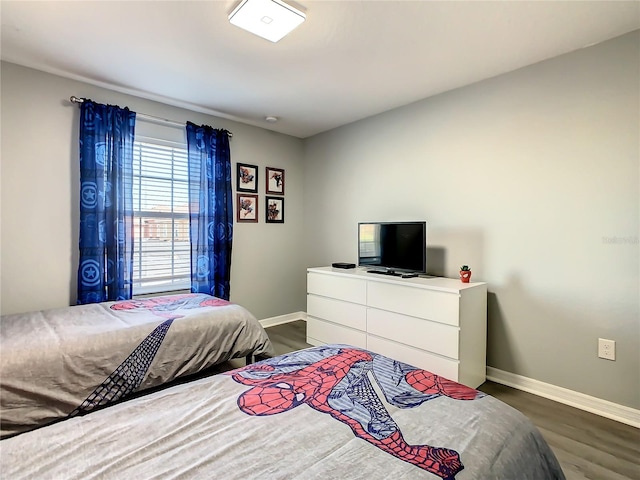 bedroom with dark hardwood / wood-style flooring