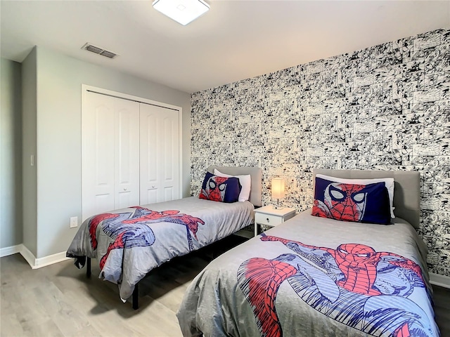 bedroom with hardwood / wood-style flooring and a closet