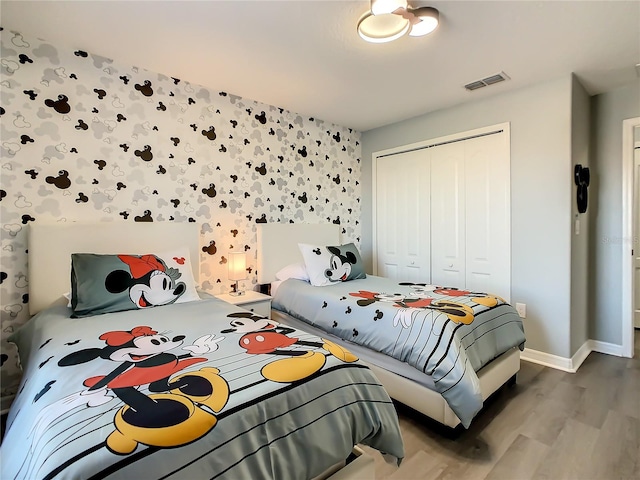 bedroom featuring hardwood / wood-style floors and a closet