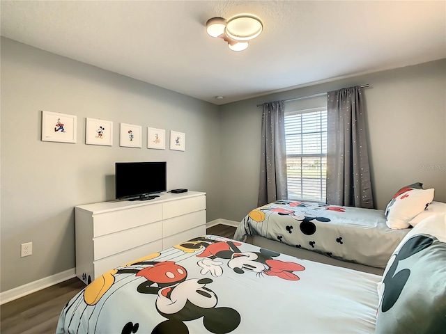 bedroom with dark hardwood / wood-style flooring