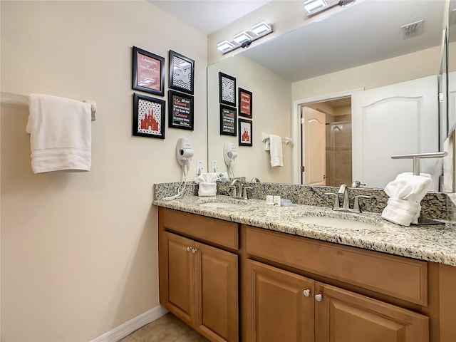 bathroom featuring a shower with door and vanity