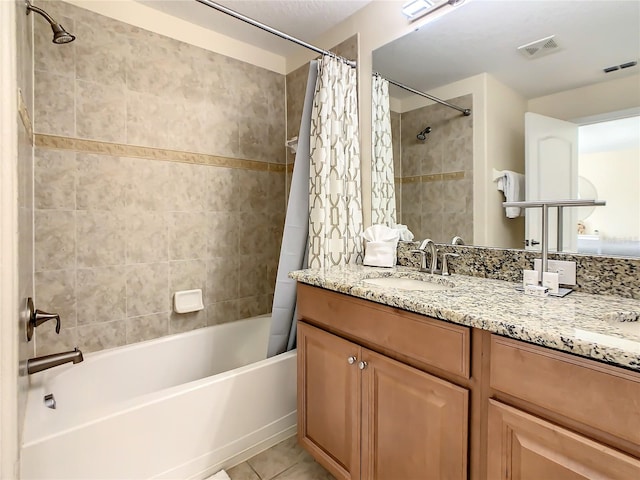 bathroom with tile patterned flooring, shower / bathtub combination with curtain, and vanity