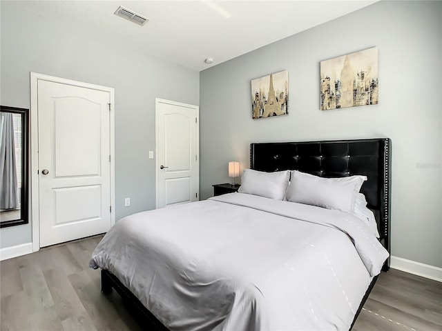 bedroom with hardwood / wood-style floors