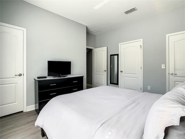 bedroom with hardwood / wood-style flooring