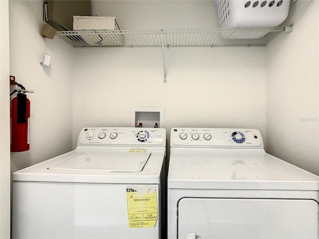 clothes washing area featuring separate washer and dryer