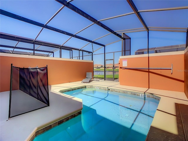 view of swimming pool with a lanai