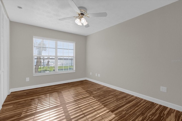 spare room featuring ceiling fan and wood-type flooring