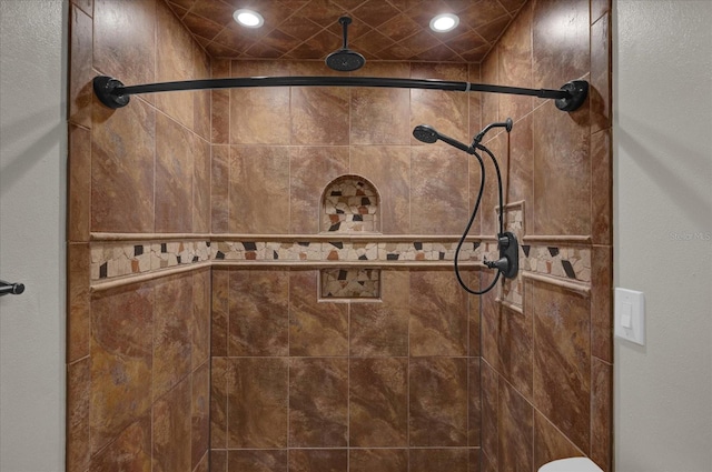 bathroom with tiled shower