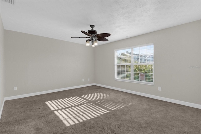 spare room with a textured ceiling, carpet flooring, and ceiling fan