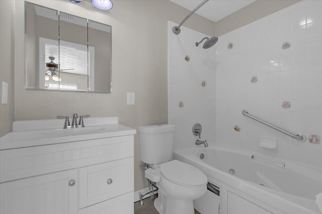 full bathroom featuring vanity, toilet, tiled shower / bath combo, and ceiling fan