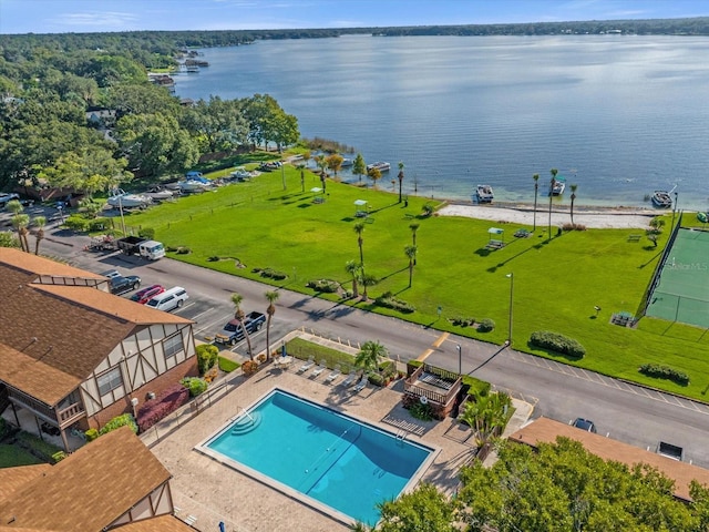 view of swimming pool featuring a water view and a patio area