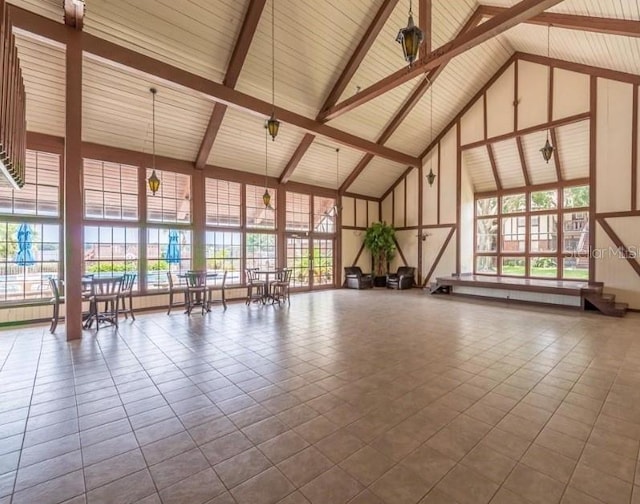 interior space with high vaulted ceiling, plenty of natural light, and tile patterned flooring