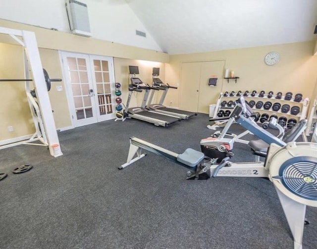 exercise room with lofted ceiling, carpet, and french doors