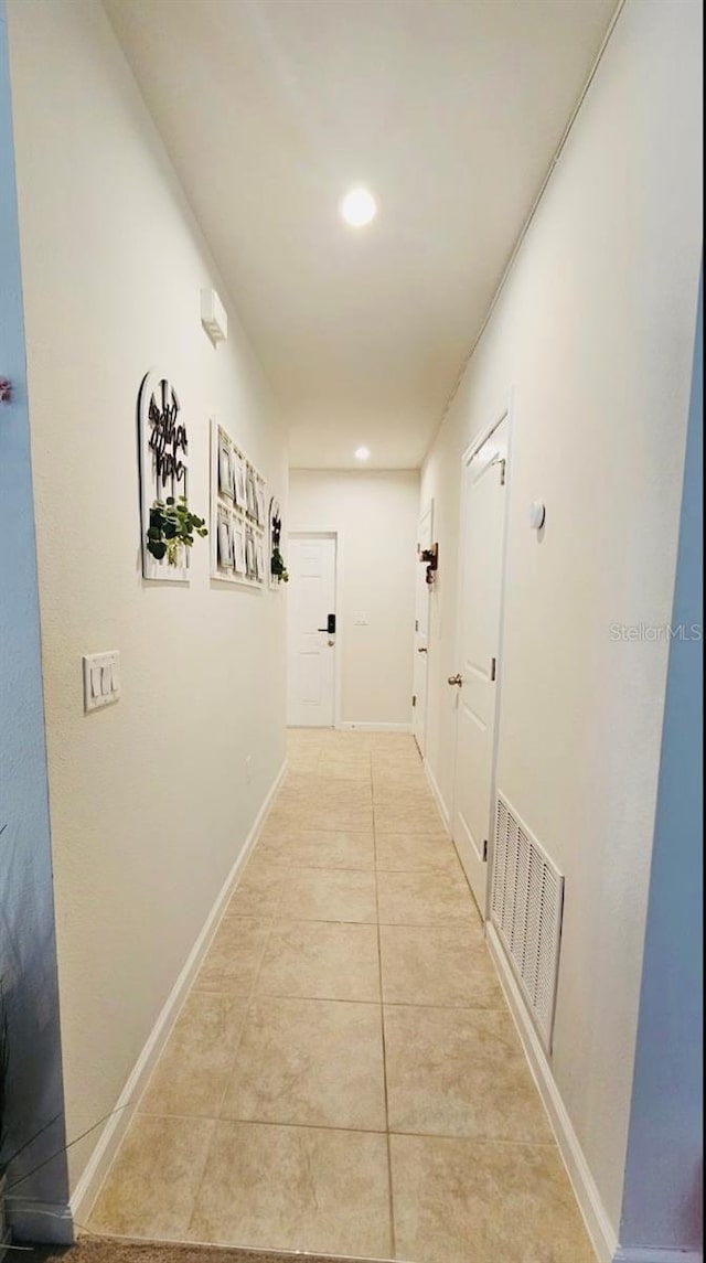 corridor with light tile patterned floors