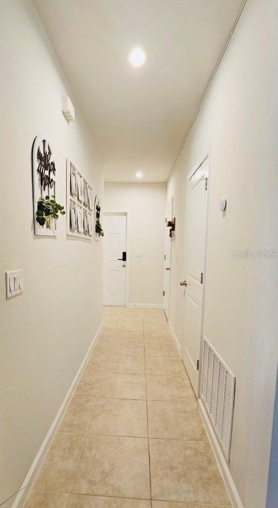 corridor featuring light tile patterned flooring