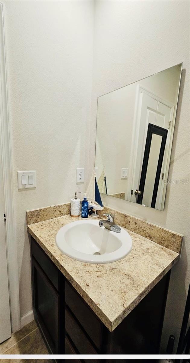 bathroom with tile patterned flooring and vanity