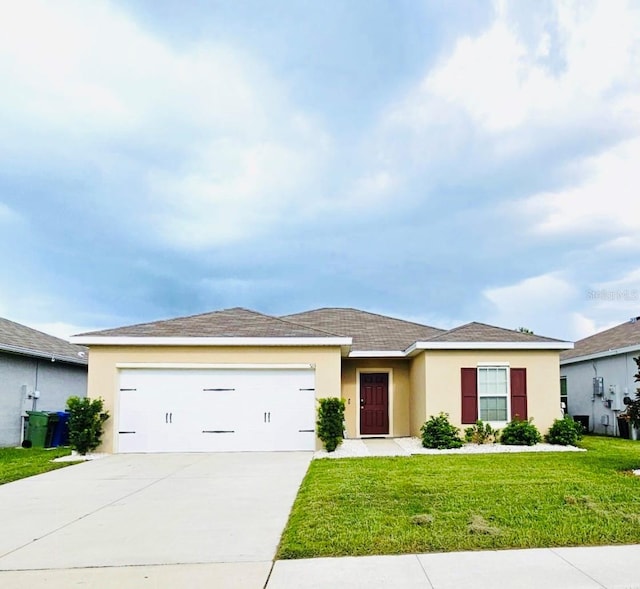 view of front of home with a garage and a front yard