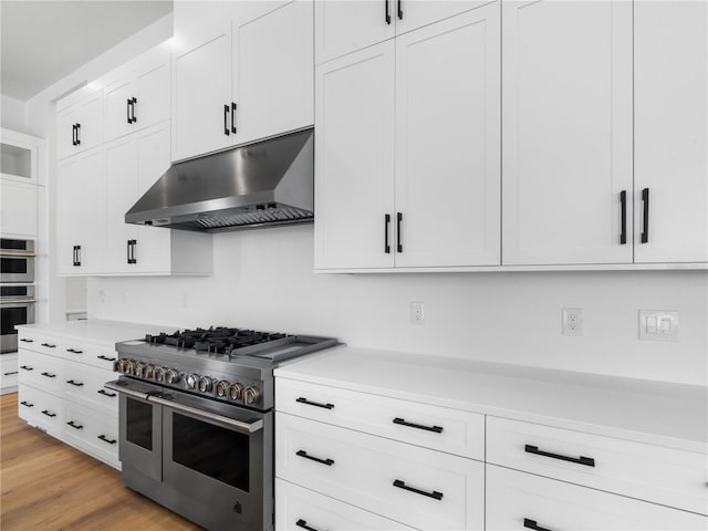 kitchen featuring white cabinetry, light hardwood / wood-style flooring, and stainless steel appliances