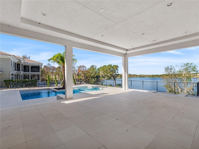 view of pool featuring a water view and a patio