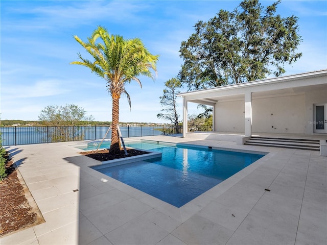 view of pool featuring a water view and a patio